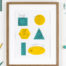 Cat art print featuring illustrations of cats over different shapes. Yellow and teal shapes with illustrations of cats over the top fitting into the shapes