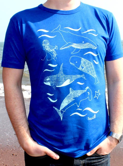 Close up of blue mens whale T-shirt featuring whales, sharks, jelly fish and star fish