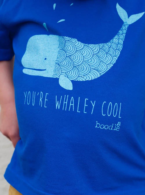 close up of whaley cool kids tee. Blue organic cotton T-shirt featuring a light blue whale