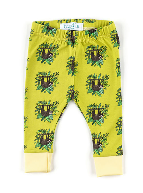 Yellow organic cotton sloth baby leggings featuring hanging sloths in a repeat pattern surrounded by jungle leaves.
