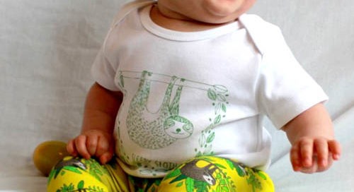 photo of a baby wearing sloth baby outfit. Sloth baby leggings paid with sloth baby T-shirt. Organic cotton