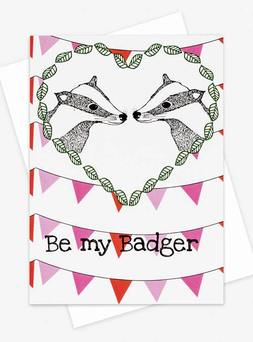 valentines birthday card featuring 2 badgers in love with the text "be my badger" underneath. With a backround if bunting