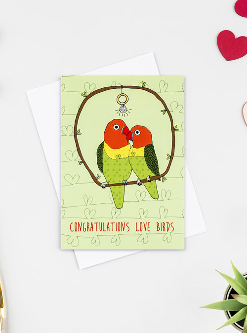 photograph of Love birds engagement card. 2 love birds on a branch with a ring hanging above with the words 'congratultions love birds' underneath