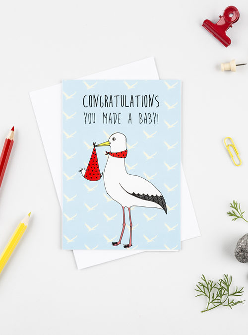 New baby card featuring a stork holding a new baby with the wording "congratulations you made a baby"
