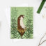 Photo of an otter and kelp card. Green card featuring an illusrration of an otter surrounded by kelp.