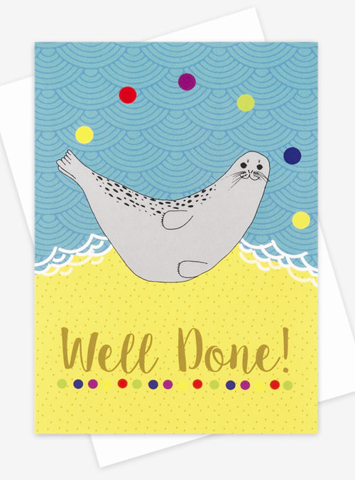 seal juggling balls on a beach with the text "well done"