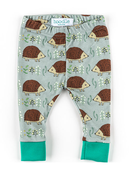 Organic cotton Hedgehog leggings featuring a repeat pattern of hedgehogs anf foliage on a green background
