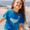 Kid model wearing a blue T-shirt with a light blue print of a whale.