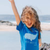Model wearing a Blue whale t-shirt on the beach.