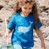 model wearing a blue organic T-shirt featuring a whale with the text 'You're whaley cool!'