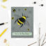 Greetings card featuring a Bumble bee with the slogan 'You're the bees knees' underneath. Grey background featuring sunflowers and bees