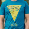 Close up of Mens T-shirt featuring a yellow triangle with a starling murmuration above and a bike below.