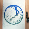 lino print of someone stepping into a marine lake/sea