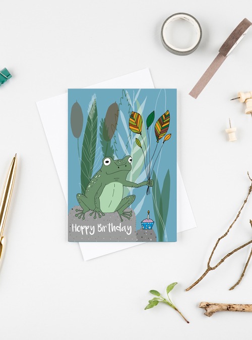 Frog card featuring a frogs on his birthday holding leaves as balloons and next to a cupcake