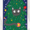 Close up of Christmas card featuring a black cat hiding in a tree playing with baubles
