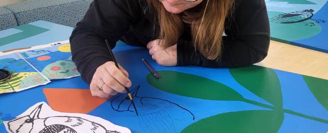 Me painting a kingfisher on the mural
