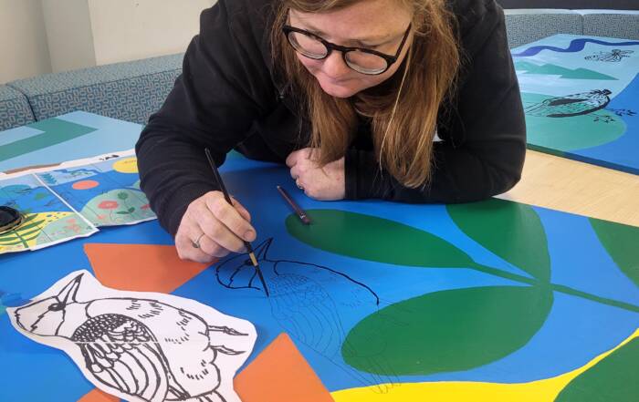 Me painting a kingfisher on the mural