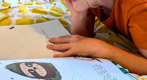 Kid reading sloth moth book