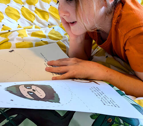 Kid reading sloth moth book