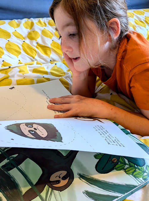 Kid reading sloth moth book