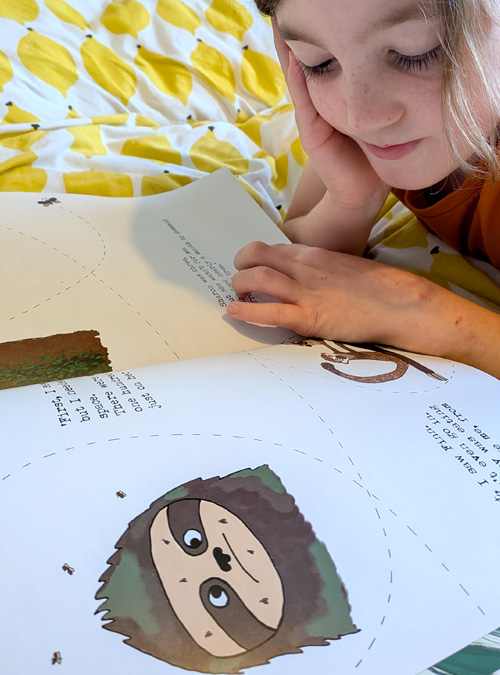 kid reading sloth moth book